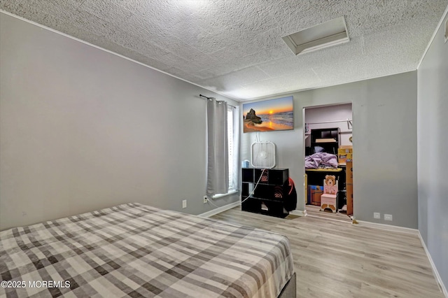 73 Barnegat Blvd S, Barnegat, NJ 08005 - bedroom with light wood-type flooring, a textured ceiling, and attic access