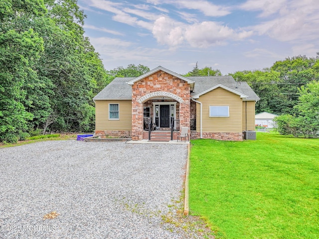 48 Brookside Ave, Old Bridge, NJ 08857 - view of front facade with stone siding, a front lawn, and covered porch