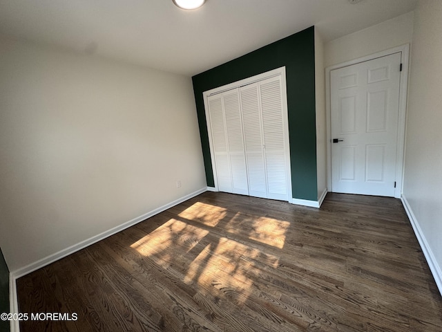 3 Churchill Downs, West Long Branch, NJ 07764 - unfurnished bedroom featuring a closet and dark wood finished floors