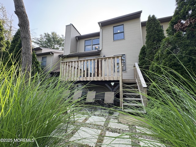 3 Churchill Downs, West Long Branch, NJ 07764 - back of property featuring a wooden deck and a chimney