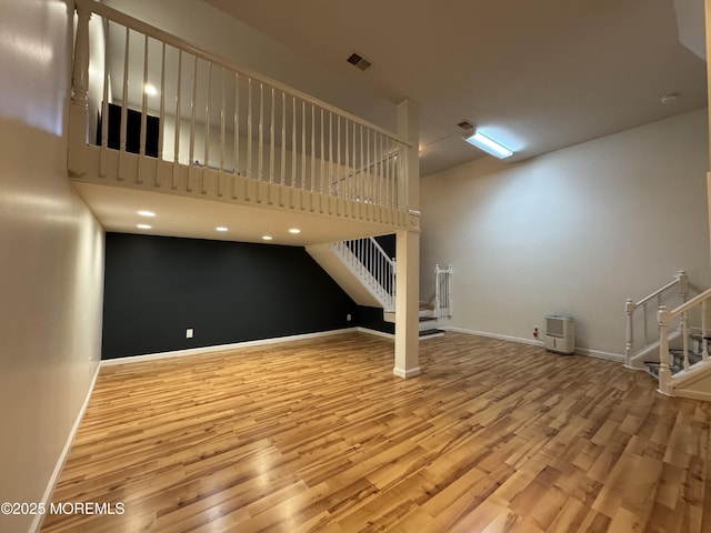 3 Churchill Downs, West Long Branch, NJ 07764 - unfurnished living room with stairs, wood finished floors, and a towering ceiling