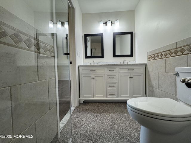 3 Churchill Downs, West Long Branch, NJ 07764 - full bath with tile walls, tiled shower, double vanity, granite floors, and a wainscoted wall