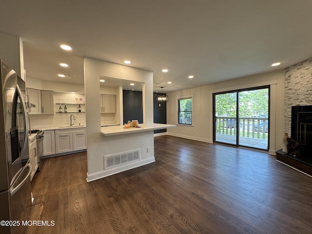 3 Churchill Downs, West Long Branch, NJ 07764 - kitchen with stainless steel appliances, dark wood-style flooring, open floor plan, light countertops, and recessed lighting