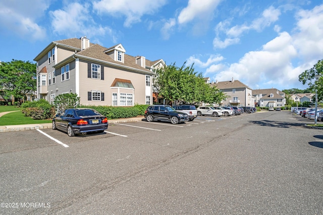 2211 Timber Ridge Ct Unit 2211, Sayreville, NJ 08859 - view of building exterior with uncovered parking and a residential view
