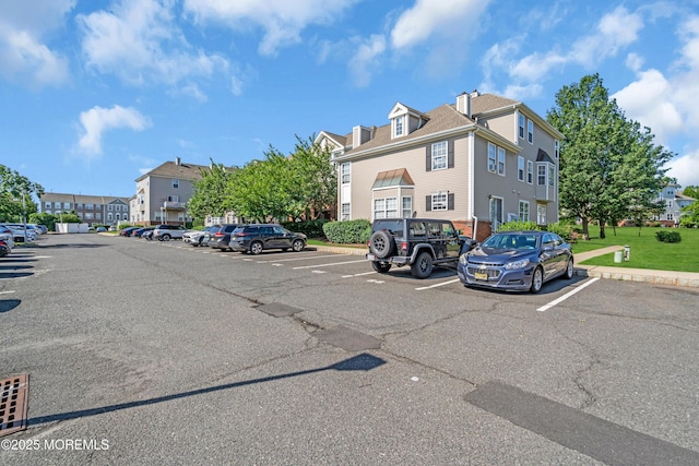 2211 Timber Ridge Ct Unit 2211, Sayreville, NJ 08859 - view of building exterior with uncovered parking and a residential view