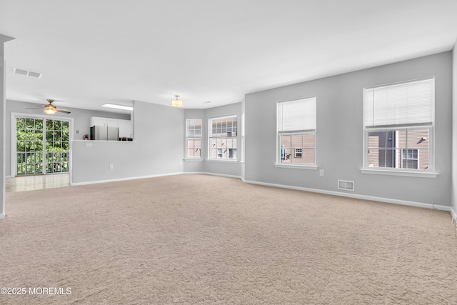 2211 Timber Ridge Ct Unit 2211, Sayreville, NJ 08859 - unfurnished living room featuring carpet, plenty of natural light, and a ceiling fan