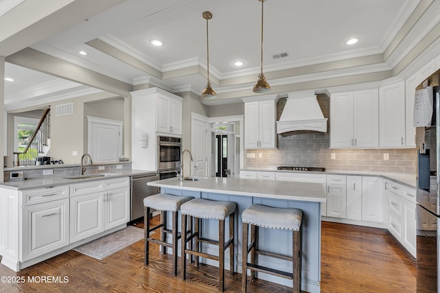 1605 Lakewood Rd, Manasquan, NJ 08736 - kitchen with custom exhaust hood, stainless steel appliances, dark wood-style floors, an island with sink, and a kitchen bar