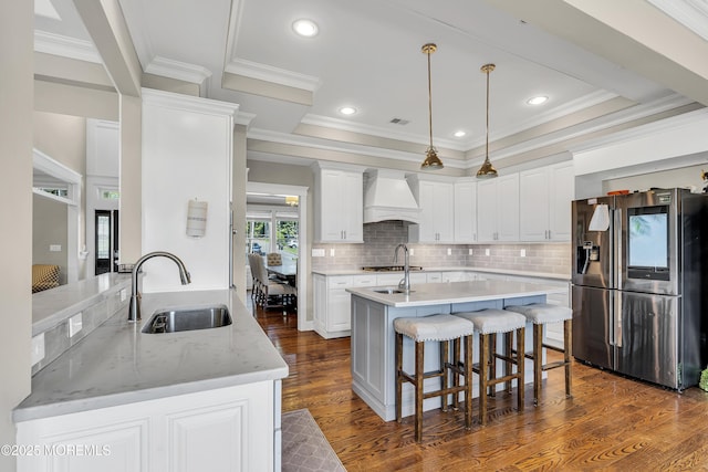 1605 Lakewood Rd, Manasquan, NJ 08736 - kitchen featuring stainless steel fridge, custom exhaust hood, dark wood-style floors, a breakfast bar area, and a kitchen island with sink