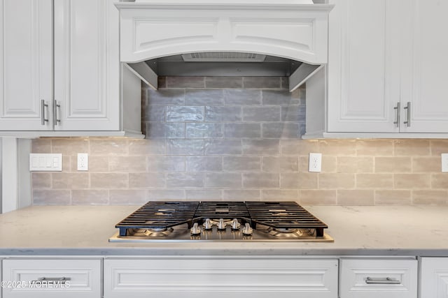 1605 Lakewood Rd, Manasquan, NJ 08736 - kitchen with stainless steel gas cooktop, white cabinets, and backsplash