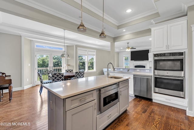 1605 Lakewood Rd, Manasquan, NJ 08736 - kitchen featuring stainless steel appliances, dark wood-style flooring, light countertops, ceiling fan, and crown molding