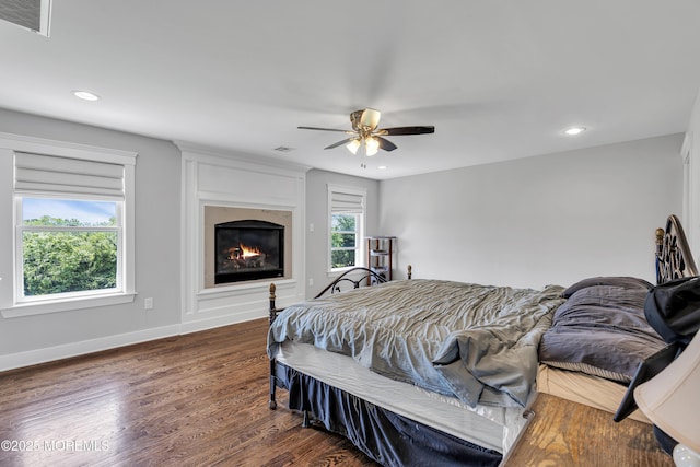 1605 Lakewood Rd, Manasquan, NJ 08736 - bedroom featuring dark wood-style flooring, recessed lighting, a ceiling fan, and a glass covered fireplace