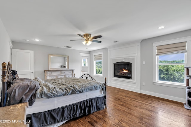 1605 Lakewood Rd, Manasquan, NJ 08736 - bedroom with wood finished floors, a glass covered fireplace, recessed lighting, and a ceiling fan
