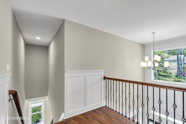 1605 Lakewood Rd, Manasquan, NJ 08736 - hallway featuring a chandelier, dark wood-type flooring, and an upstairs landing