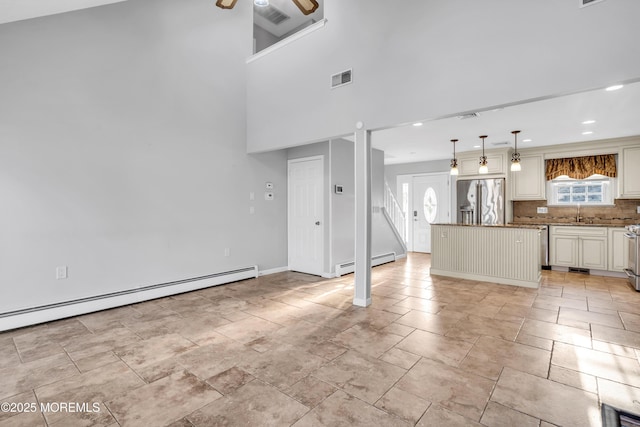 91 Wind Jammer Ct, Bayville, NJ 08721 - unfurnished living room with a baseboard heating unit, plenty of natural light, ceiling fan, a high ceiling, and recessed lighting