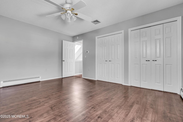 91 Wind Jammer Ct, Bayville, NJ 08721 - unfurnished bedroom with a baseboard heating unit, multiple closets, wood finished floors, ceiling fan, and a textured ceiling