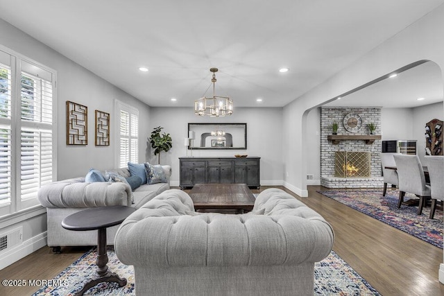 32 Blackbriar Dr, Colts Neck, NJ 07722 - living room featuring arched walkways, wood finished floors, a chandelier, and recessed lighting
