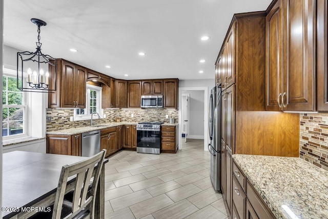 32 Blackbriar Dr, Colts Neck, NJ 07722 - kitchen featuring stainless steel appliances, decorative backsplash, light stone countertops, recessed lighting, and hanging light fixtures