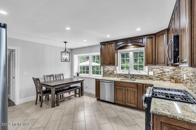 32 Blackbriar Dr, Colts Neck, NJ 07722 - kitchen featuring appliances with stainless steel finishes, backsplash, light stone counters, hanging light fixtures, and recessed lighting