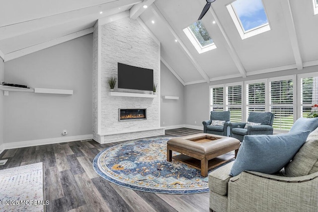 32 Blackbriar Dr, Colts Neck, NJ 07722 - living area with beamed ceiling, a skylight, wood finished floors, high vaulted ceiling, and a fireplace