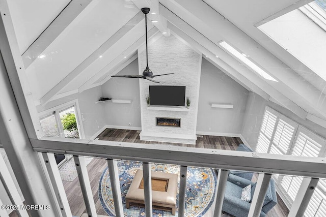 32 Blackbriar Dr, Colts Neck, NJ 07722 - unfurnished living room featuring a fireplace, wood finished floors, and a ceiling fan