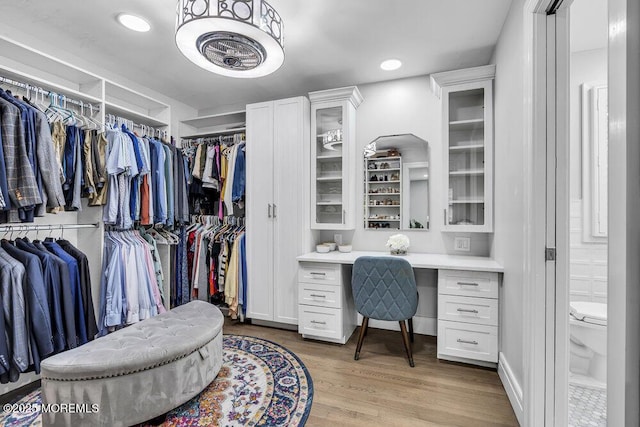 32 Blackbriar Dr, Colts Neck, NJ 07722 - spacious closet featuring built in study area and light wood-style flooring