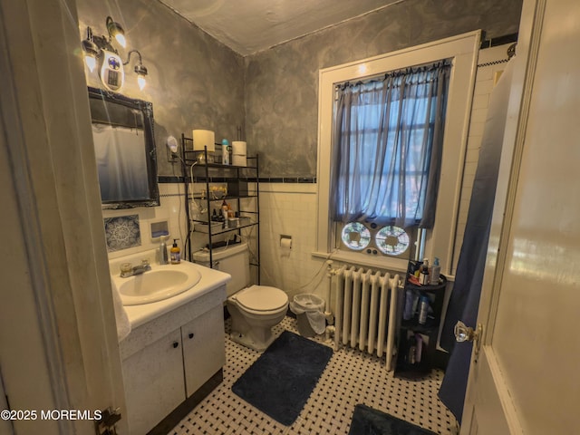 192 Bath Ave, Long Branch, NJ 07740 - bathroom featuring radiator heating unit, vanity, wainscoting, a shower with shower curtain, and tile walls