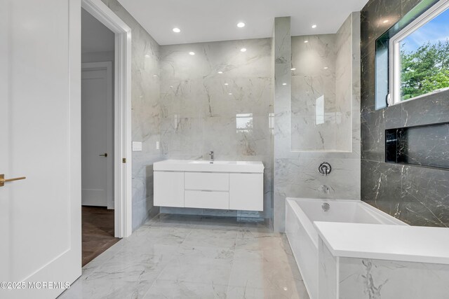 1423 Anthony Ct, Toms River, NJ 08753 - bathroom with marble tiled flooring, tile walls, a bathtub, vanity, and recessed lighting