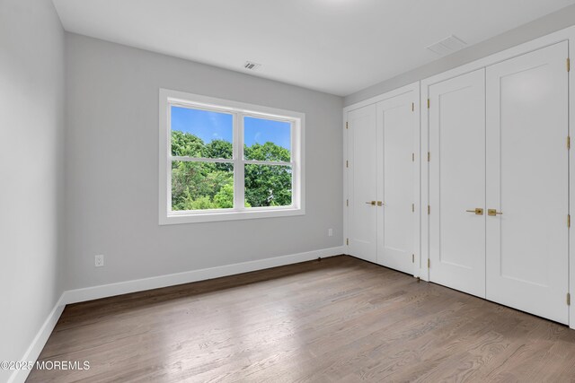 1423 Anthony Ct, Toms River, NJ 08753 - unfurnished bedroom with multiple closets and wood finished floors
