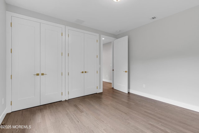 1423 Anthony Ct, Toms River, NJ 08753 - unfurnished bedroom featuring wood finished floors and multiple closets