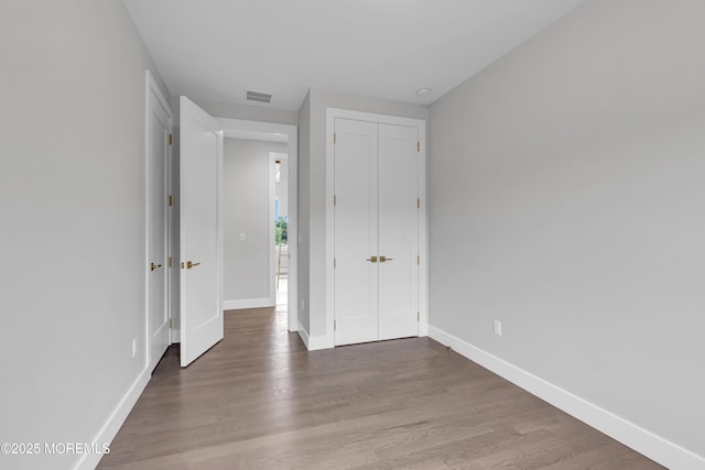 1423 Anthony Ct, Toms River, NJ 08753 - unfurnished bedroom featuring wood finished floors and a closet