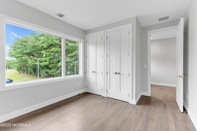 1423 Anthony Ct, Toms River, NJ 08753 - unfurnished bedroom featuring multiple closets and wood finished floors