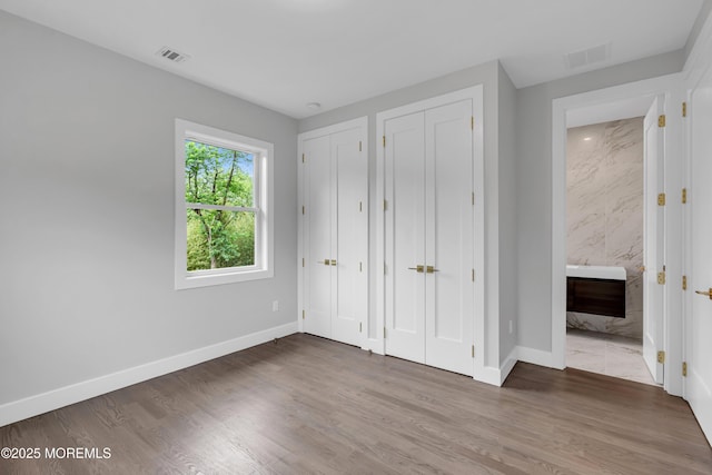 1423 Anthony Ct, Toms River, NJ 08753 - unfurnished bedroom with multiple closets, wood finished floors, and ensuite bathroom