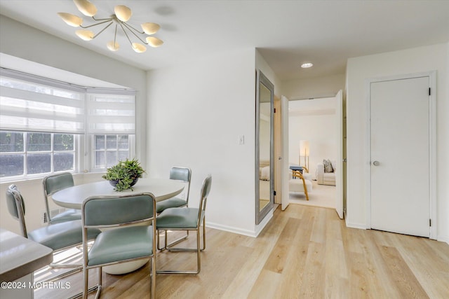 12 Harbor Ct, West Long Branch, NJ 07764 - dining room with a chandelier and light wood-style floors