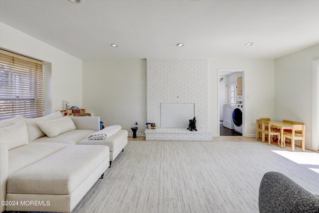 12 Harbor Ct, West Long Branch, NJ 07764 - living area with healthy amount of natural light, washer / dryer, a brick fireplace, wood finished floors, and recessed lighting