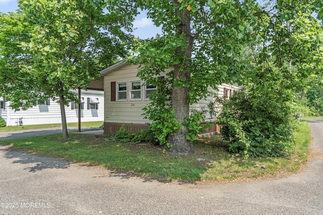 124 Village Rd, Morganville, NJ 07751 - view of front facade featuring a carport