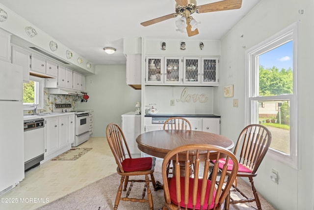 124 Village Rd, Morganville, NJ 07751 - dining room featuring light flooring, ceiling fan, washer / clothes dryer, and a dry bar