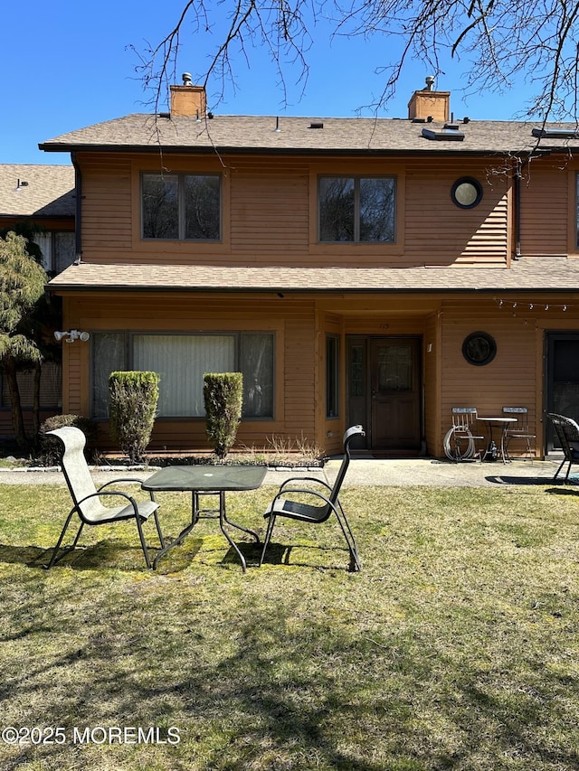 115 Brandywine Ct Unit 115, Brick, NJ 08724 - rear view of property featuring a chimney and a yard