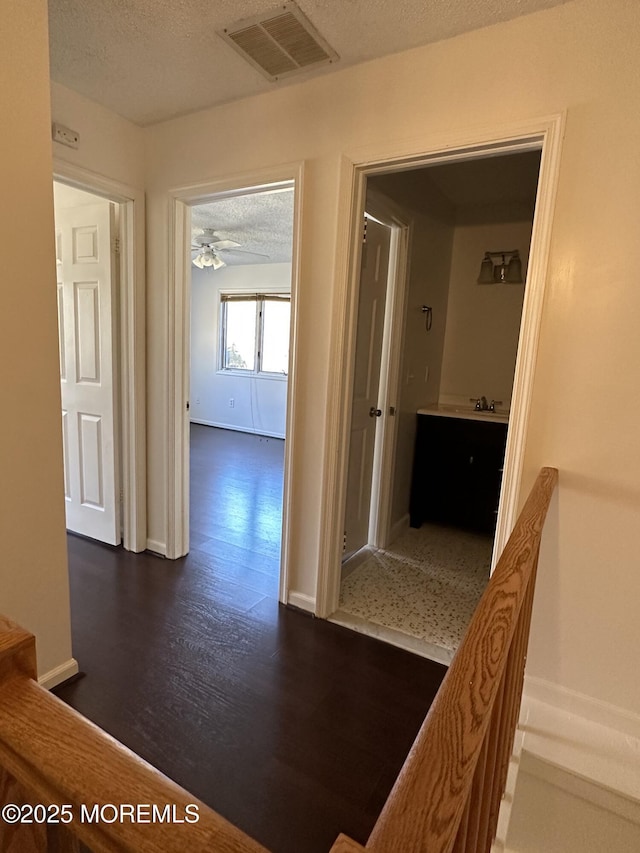 115 Brandywine Ct Unit 115, Brick, NJ 08724 - hallway with a textured ceiling and dark wood-style floors