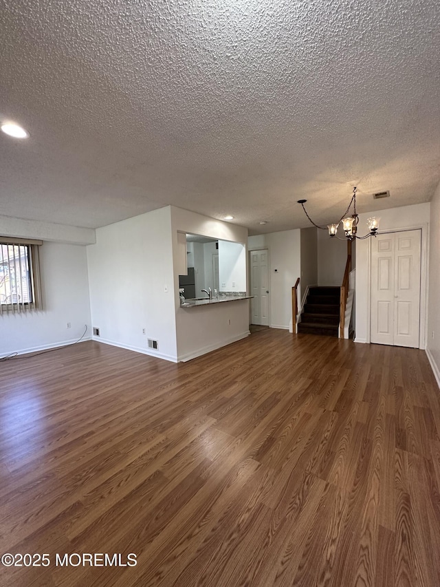 115 Brandywine Ct Unit 115, Brick, NJ 08724 - unfurnished living room with a textured ceiling, dark wood-style floors, stairway, a chandelier, and recessed lighting