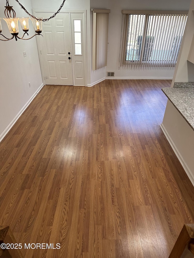 115 Brandywine Ct Unit 115, Brick, NJ 08724 - unfurnished dining area featuring a chandelier and dark wood-style floors