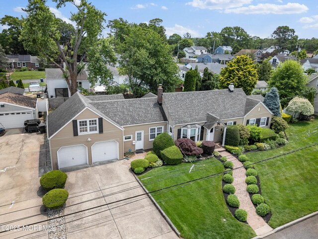 149 9th St, Belford, NJ 07718 - view of front of home featuring a garage, concrete driveway, a residential view, a front lawn, and a chimney