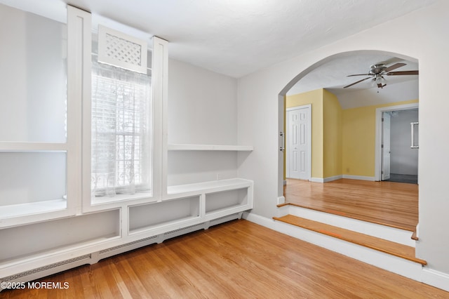 149 9th St, Belford, NJ 07718 - interior space with arched walkways, a ceiling fan, and wood finished floors