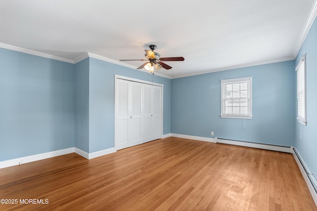 149 9th St, Belford, NJ 07718 - unfurnished bedroom featuring light wood-type flooring, baseboard heating, a closet, crown molding, and a ceiling fan