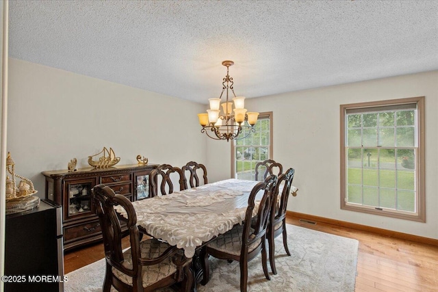 519 Gilford Ave, Toms River, NJ 08753 - dining space featuring a chandelier, healthy amount of natural light, light wood-style flooring, and a textured ceiling
