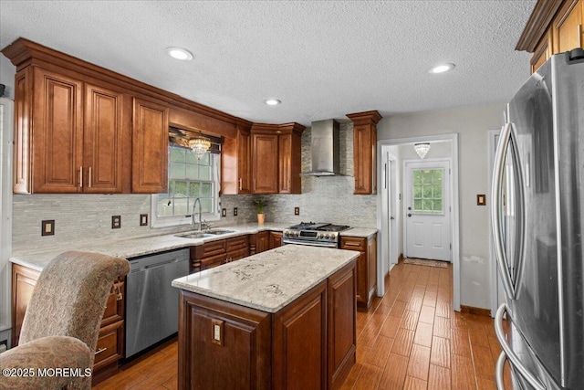 519 Gilford Ave, Toms River, NJ 08753 - kitchen with appliances with stainless steel finishes, wall chimney range hood, wood-type flooring, decorative backsplash, and a textured ceiling
