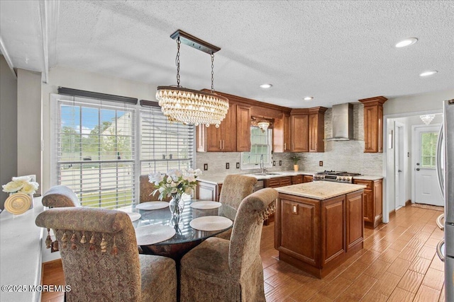 519 Gilford Ave, Toms River, NJ 08753 - kitchen with wall chimney exhaust hood, a textured ceiling, light countertops, brown cabinetry, and recessed lighting