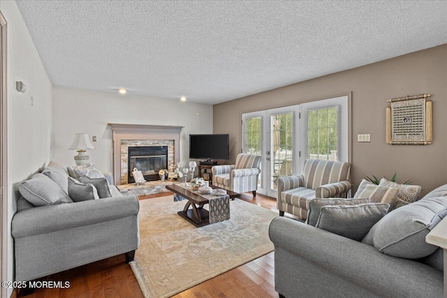 519 Gilford Ave, Toms River, NJ 08753 - living area with wood finished floors, a textured ceiling, and a stone fireplace