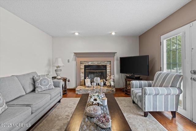 519 Gilford Ave, Toms River, NJ 08753 - living room with wood finished floors, a textured ceiling, a fireplace, and recessed lighting