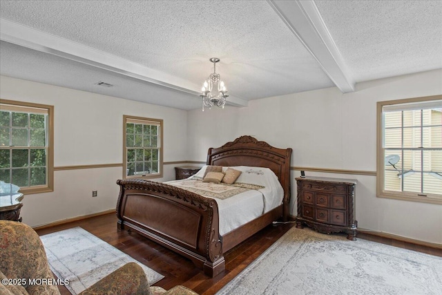 519 Gilford Ave, Toms River, NJ 08753 - bedroom with beamed ceiling, a textured ceiling, wood finished floors, multiple windows, and a chandelier