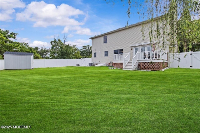 519 Gilford Ave, Toms River, NJ 08753 - rear view of house featuring a wooden deck, a fenced backyard, and a storage unit